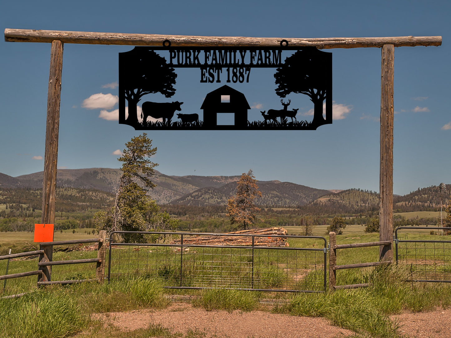 Farm Sign with a Barn, Cows, and Deer